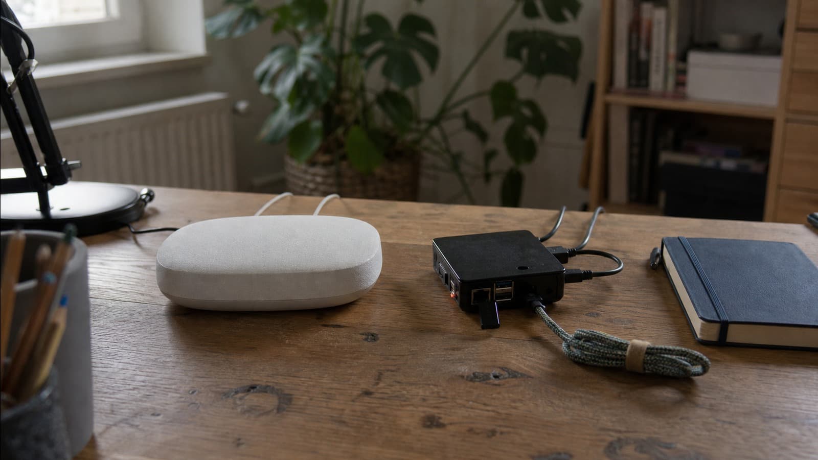 Unbranded rounded smart-home hub alongside a DIY single-board automation controller